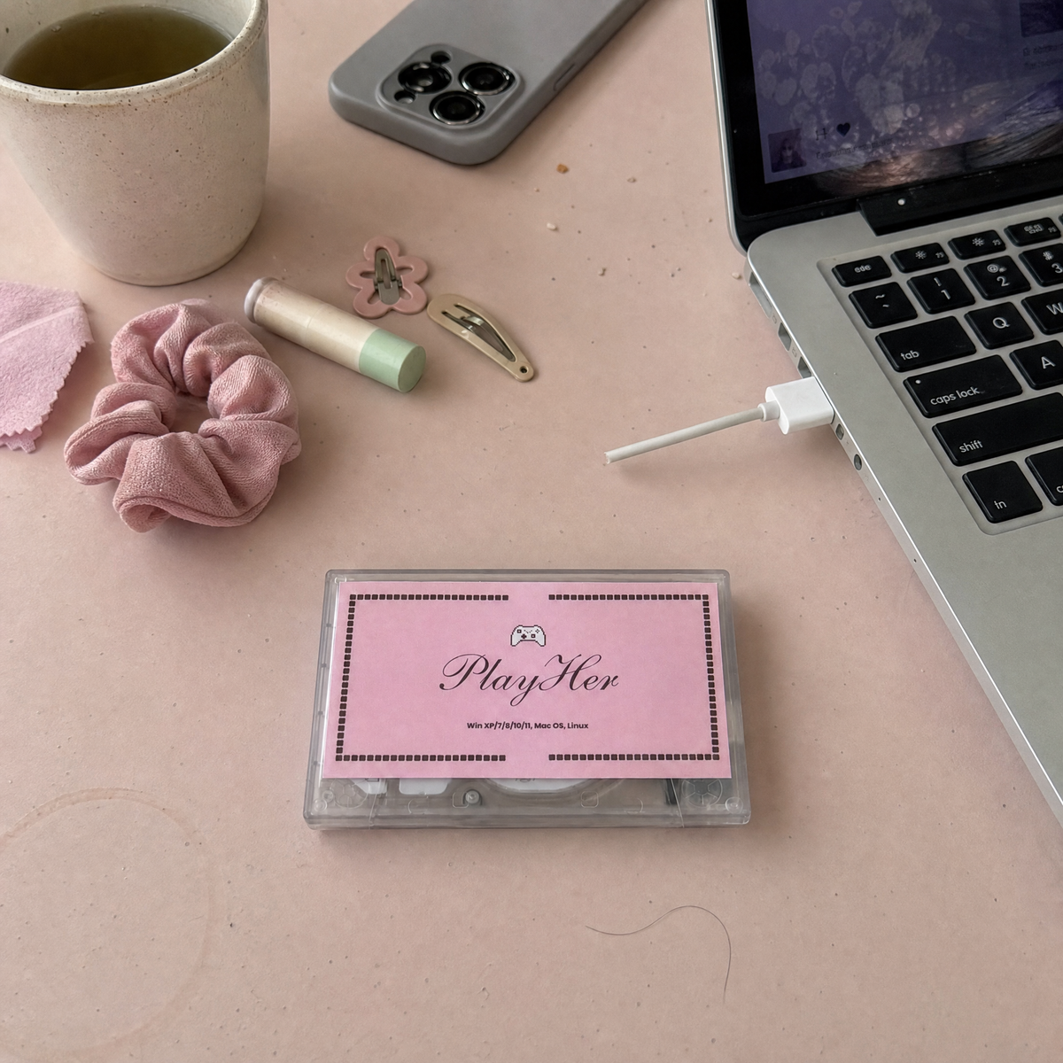 PlayHer console beside an open laptop