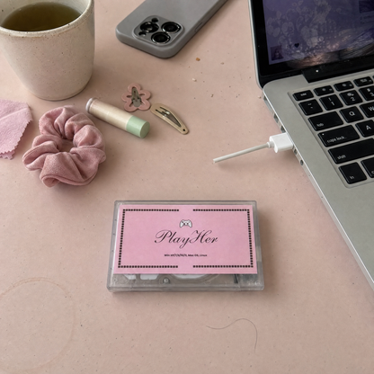 PlayHer console beside an open laptop